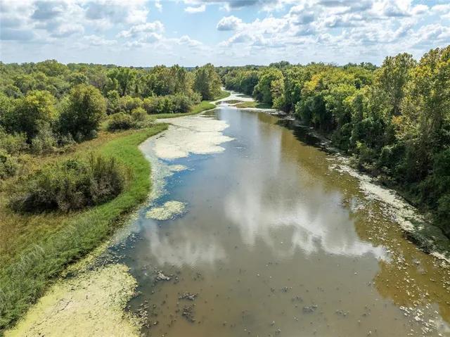 a view of a water pond with green space
