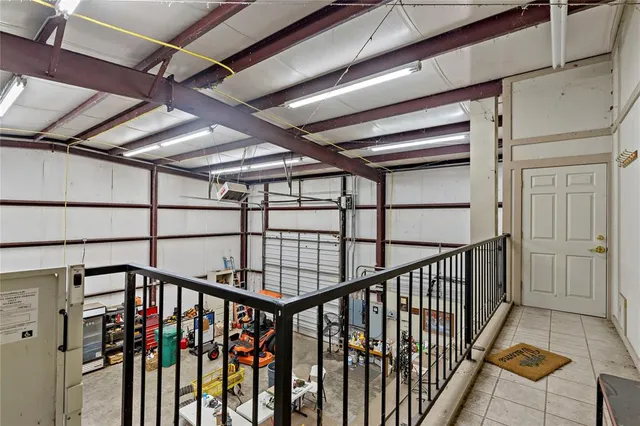 a living room with lots of furniture a rug and white walls