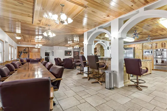 a kitchen with stainless steel appliances kitchen island granite countertop a sink and cabinets