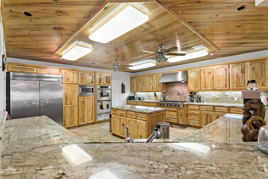 0 Fm 410 Detroit, TX 75436 - Photo 27 of 40 a kitchen with stainless steel appliances kitchen island granite countertop a sink and cabinets