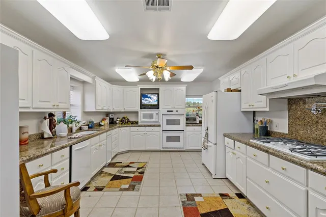 a bedroom with furniture and a ceiling fan