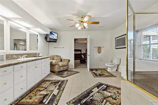 a very nice looking living room with a large window and stainless steel appliances