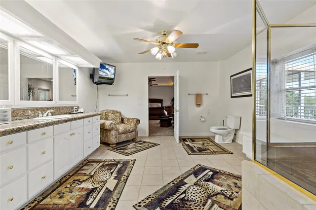 a very nice looking living room with a large window and stainless steel appliances