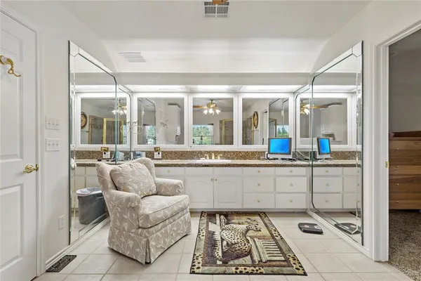 a view of a balcony with furniture and floor to ceiling window