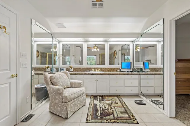 a view of a balcony with furniture and floor to ceiling window