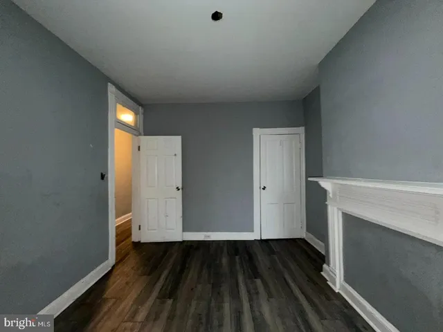 a view of hallway with wooden floor