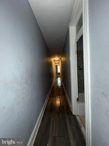 a view of a hallway with wooden shelves