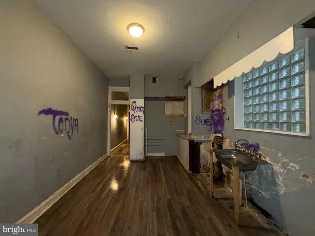 a view of entryway with workspace and wooden floor