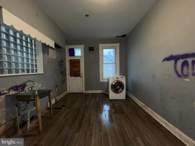 a very nice looking room with wooden floor and furniture