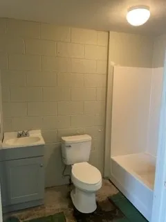 a bathroom with a toilet sink and shower