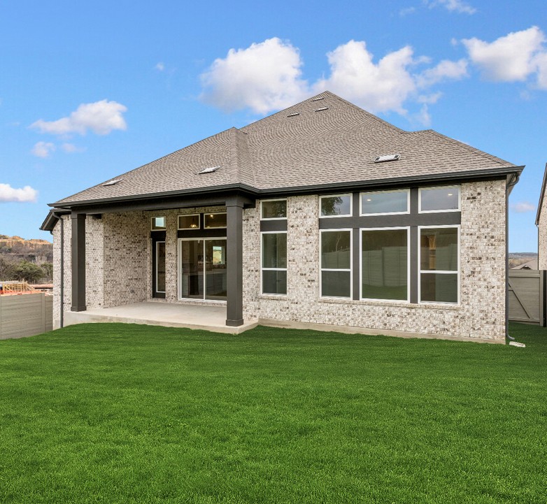 2005 Sundown Trail Georgetown, TX 78628 - Photo 11 of 18 a front view of a house with a garden and yard