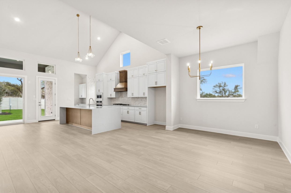 2005 Sundown Trail Georgetown, TX 78628 - Photo 5 of 18 a large kitchen with cabinets a sink a window and stainless steel appliances
