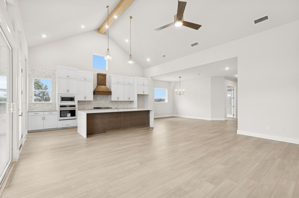 2005 Sundown Trail Georgetown, TX 78628 - Photo 6 of 18 a large kitchen with kitchen island a sink stainless steel appliances and cabinets