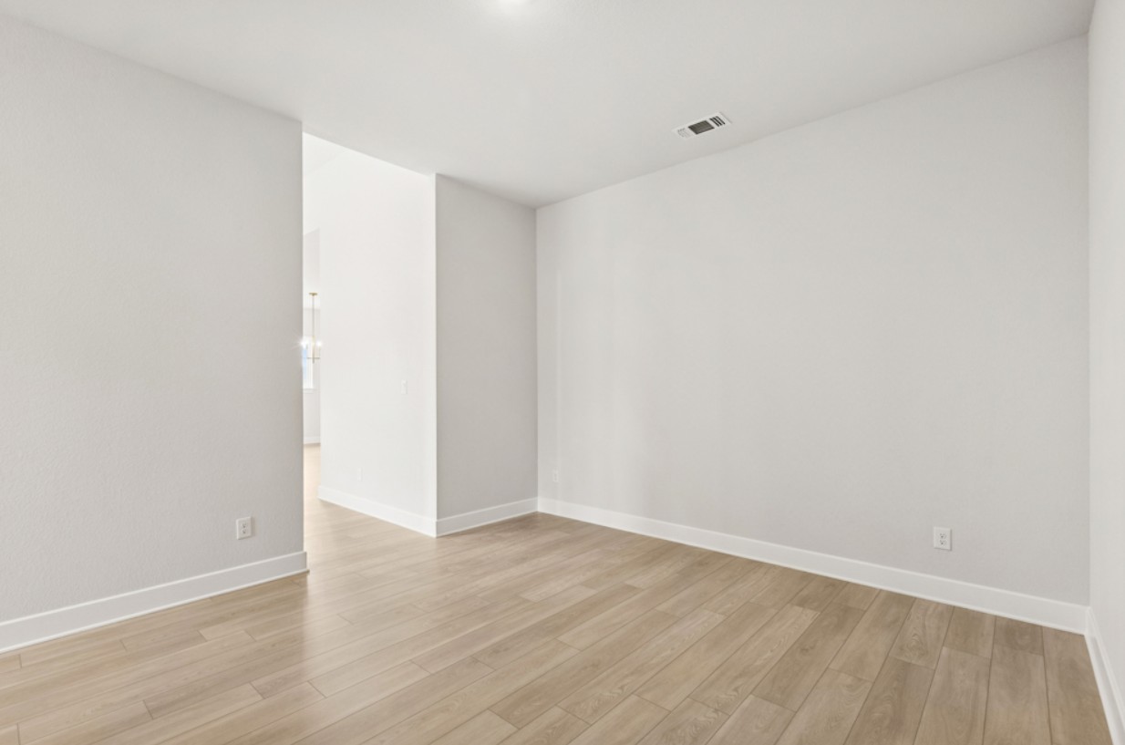 2005 Sundown Trail Georgetown, TX 78628 - Photo 8 of 18 a view of an empty room with wooden floor
