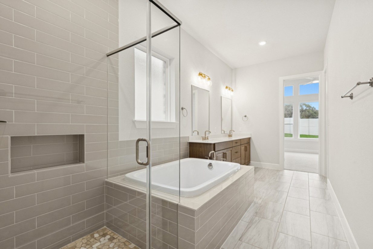 2005 Sundown Trail Georgetown, TX 78628 - Photo 10 of 18 a bathroom with a sink a mirror and shower