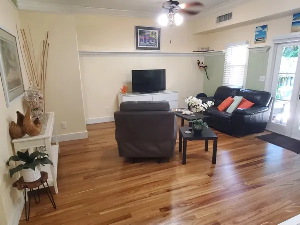 a view of entryway and hall with wooden floor