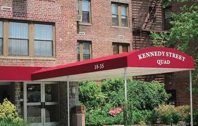 a red sign board on the side of a building