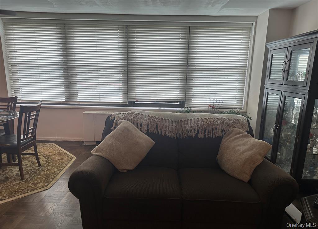 18-35 Corporal Kennedy Street, Unit 1F Queens, NY 11360 - Photo 4 of 9 a living room with furniture and large windows