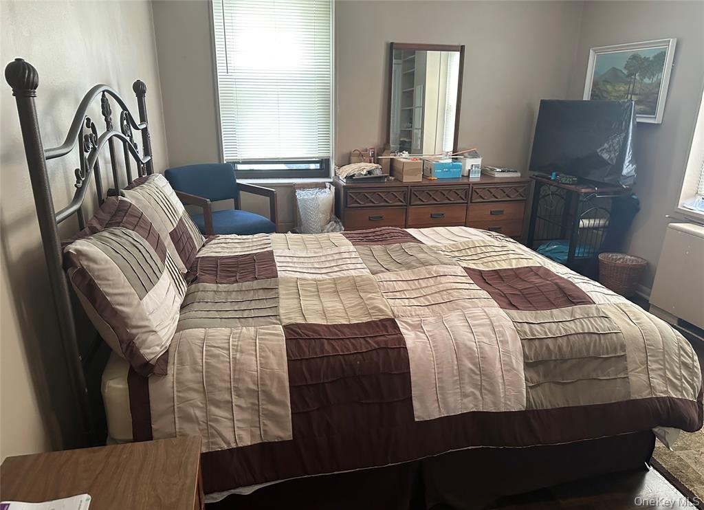 18-35 Corporal Kennedy Street, Unit 1F Queens, NY 11360 - Photo 9 of 9 a bedroom with a bed and wooden floor