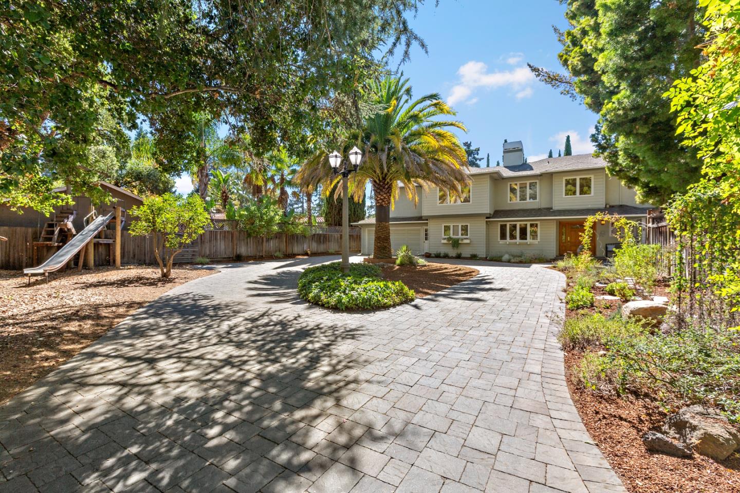 1591 Dennis Lane Mountain View, CA 94040 - Photo 1 of 1 a view of a street with potted plants and large trees