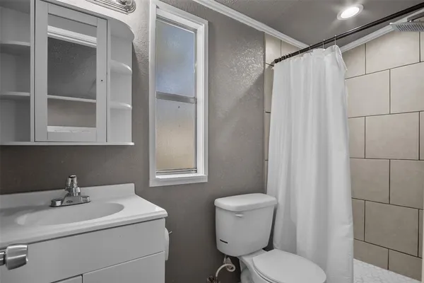 a bathroom with a sink toilet and a mirror