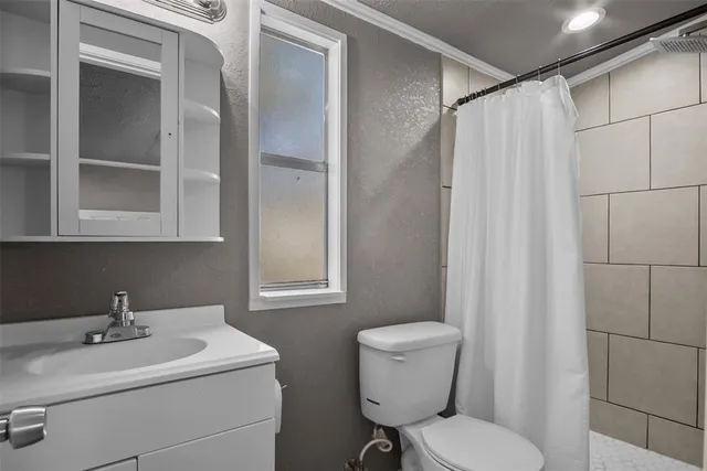 a bedroom with bed and a flat screen tv