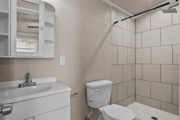 a bathroom with a sink toilet and shower