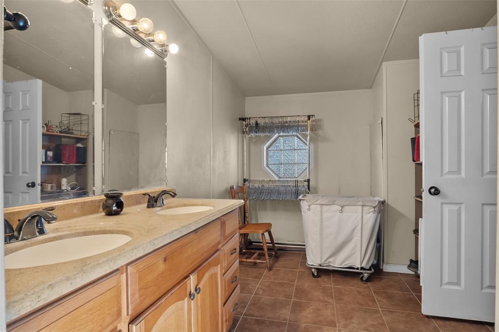 353 Prairie Lane Azle, TX 76020 - Photo 19 of 36 a room with sink mirror and furniture