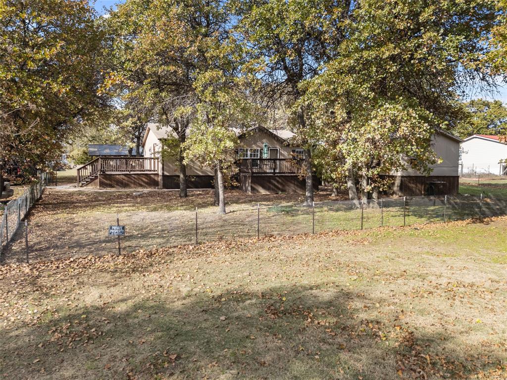 353 Prairie Lane Azle, TX 76020 - Photo 2 of 36 a backyard of a house with lots of green space