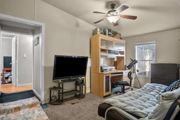 a bedroom with bed and a flat screen tv