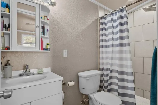 a bathroom with a sink toilet and shower