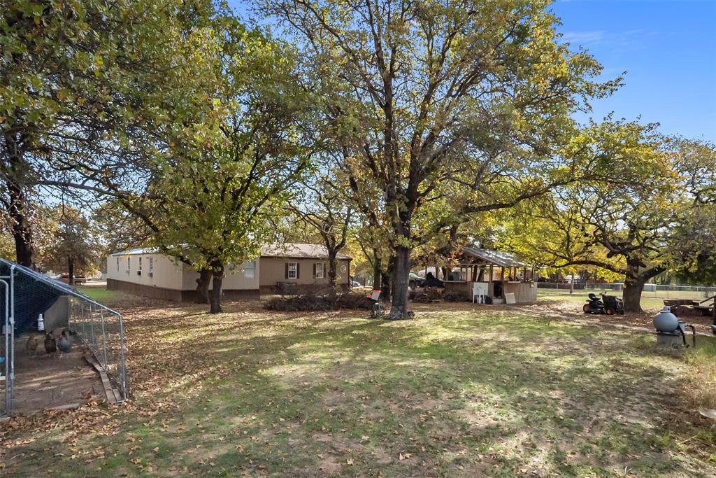 353 Prairie Lane Azle, TX 76020 - Photo 4 of 36 a view of a house with a large tree