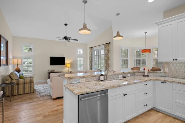 a kitchen with granite countertop a stove and a sink