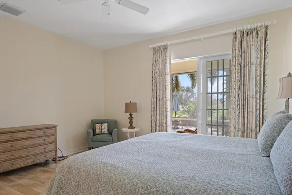 a spacious bedroom with a bed and glass door