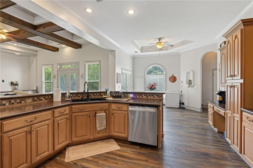 166 Freedom Lane Commerce, GA 30530 - Photo 14 of 25 a large kitchen with stainless steel appliances a stove a sink dishwasher and wooden cabinets with wooden floor