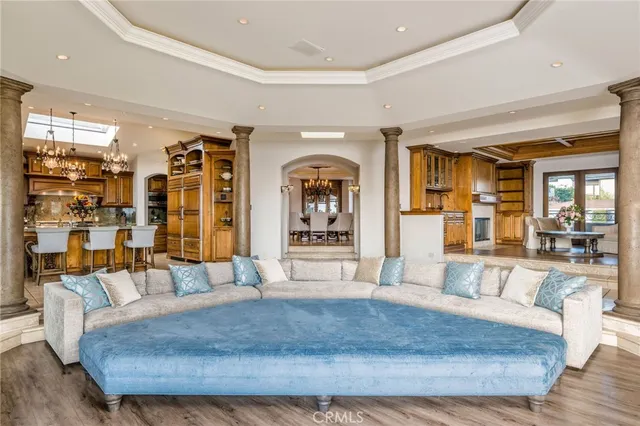 a dining room with furniture a fireplace and wooden floor