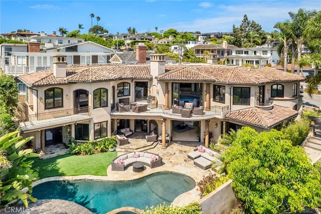 a front view of a house with swimming pool having outdoor seating