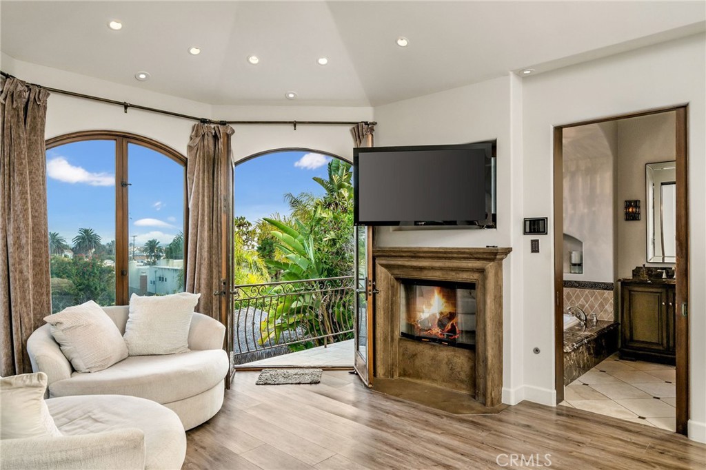 215 South Poinsettia Avenue Manhattan Beach, CA 90266 - Photo 23 of 64 a living room with furniture a fireplace and a flat screen tv