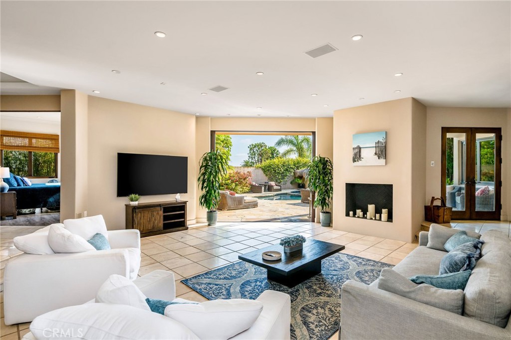 215 South Poinsettia Avenue Manhattan Beach, CA 90266 - Photo 32 of 64 a living room with furniture a fireplace and a flat screen tv
