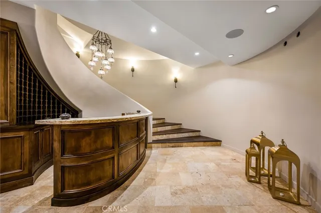 a view of a patio with couches and table and chairs with wooden fence and plants