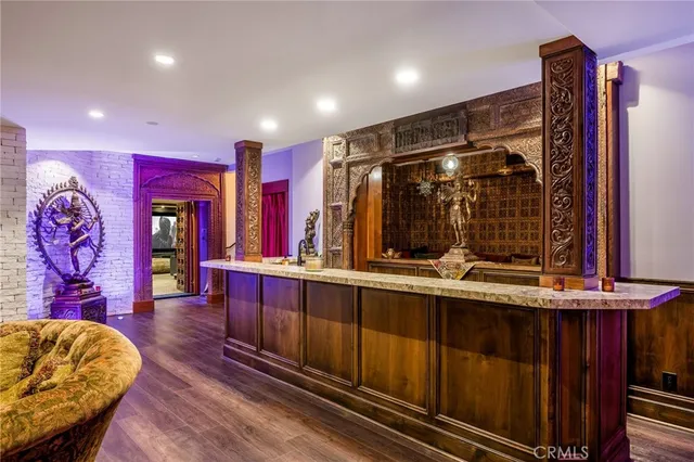 a backyard of a house with table and chairs under an umbrella