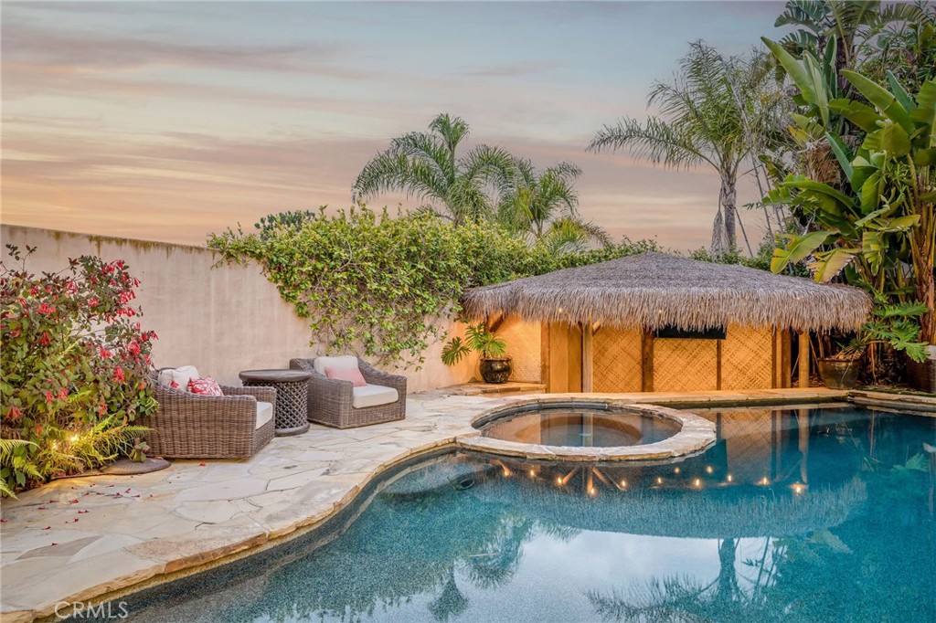 215 South Poinsettia Avenue Manhattan Beach, CA 90266 - Photo 56 of 64 a backyard of a house with table and chairs under an umbrella