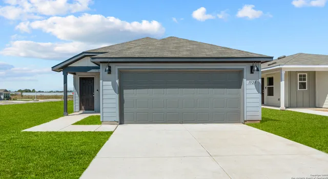 a front view of a house with a yard