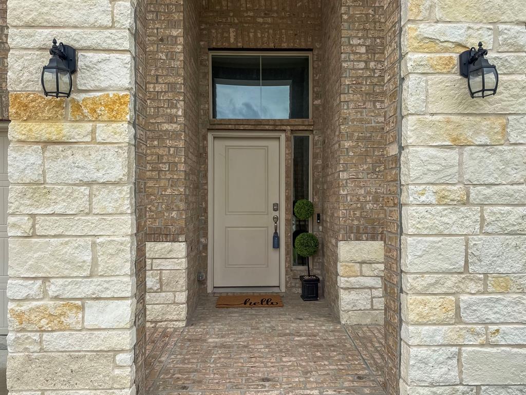 200 Tanager Drive Rhome, TX 76078 - Photo 5 of 31 Stone and brick combo with coach lights.