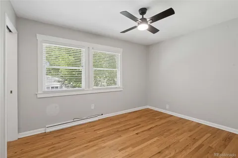 a view of empty room with wooden floor