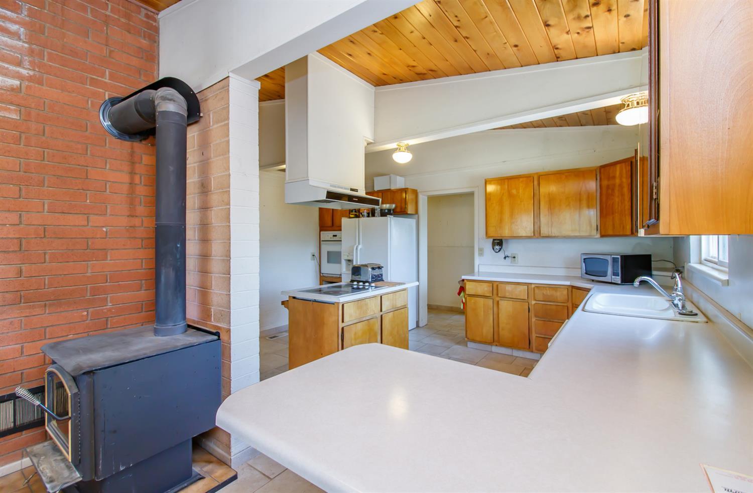 1039 West Valley View Road Ashland, OR 97520 - Photo 10 of 32 a kitchen with a table chairs in it and wooden floors