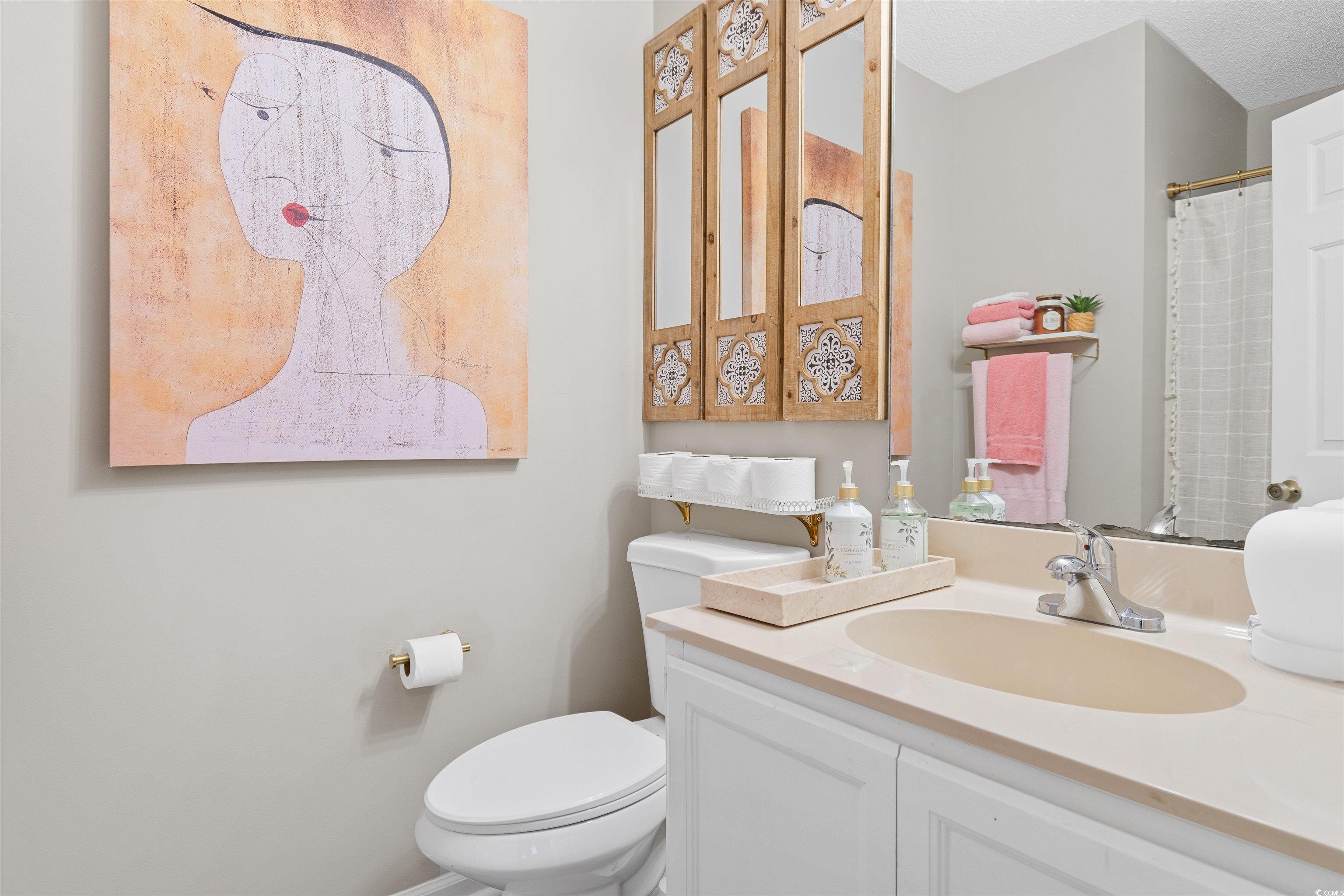 1830 Fairway Ridge Drive, Unit 6F Myrtle Beach, SC 29575 - Photo 19 of 31 Bathroom with vanity, a textured ceiling, and toil