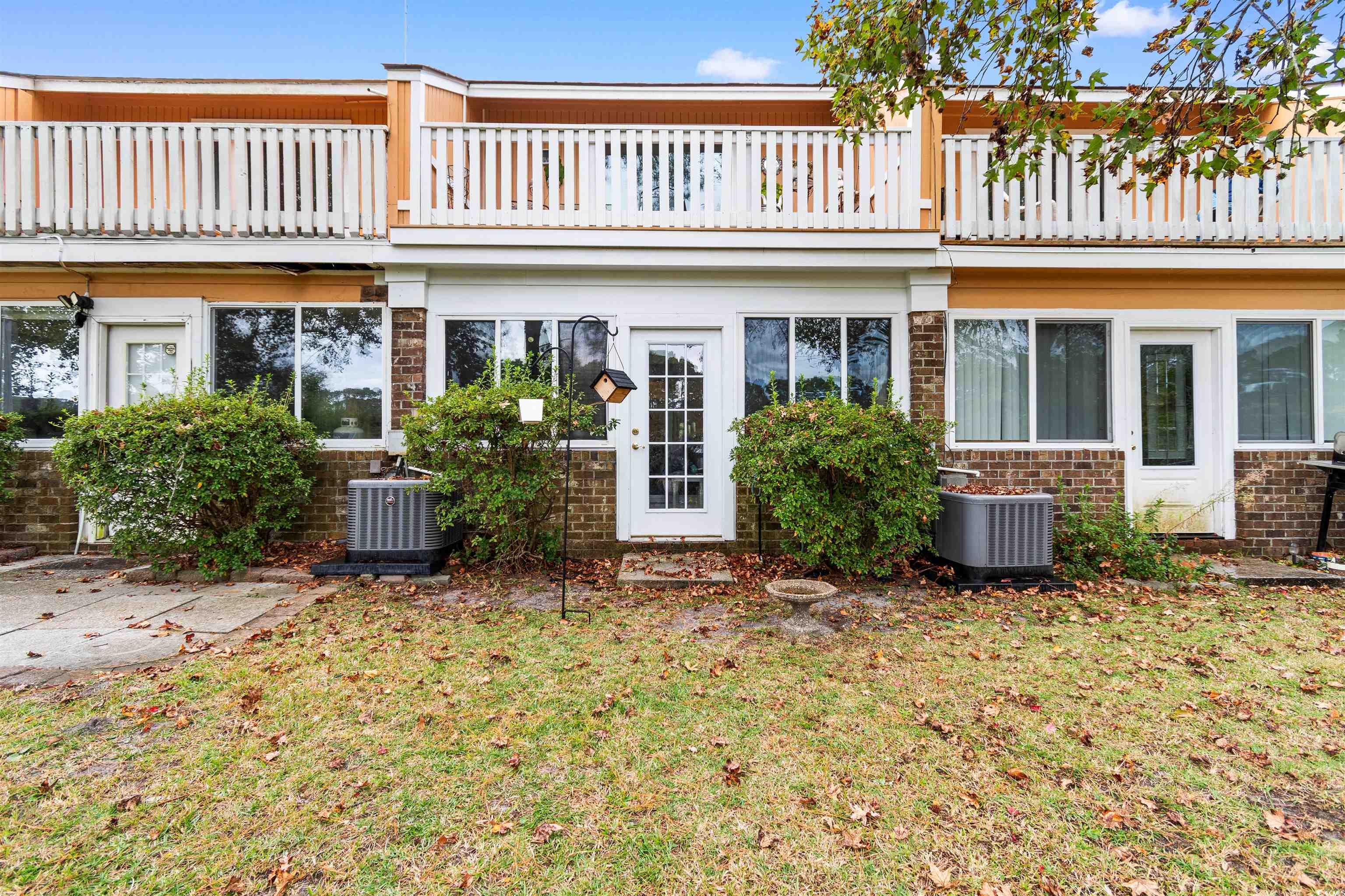 1830 Fairway Ridge Drive, Unit 6F Myrtle Beach, SC 29575 - Photo 24 of 31 Rear view of house featuring central AC, a yard, a