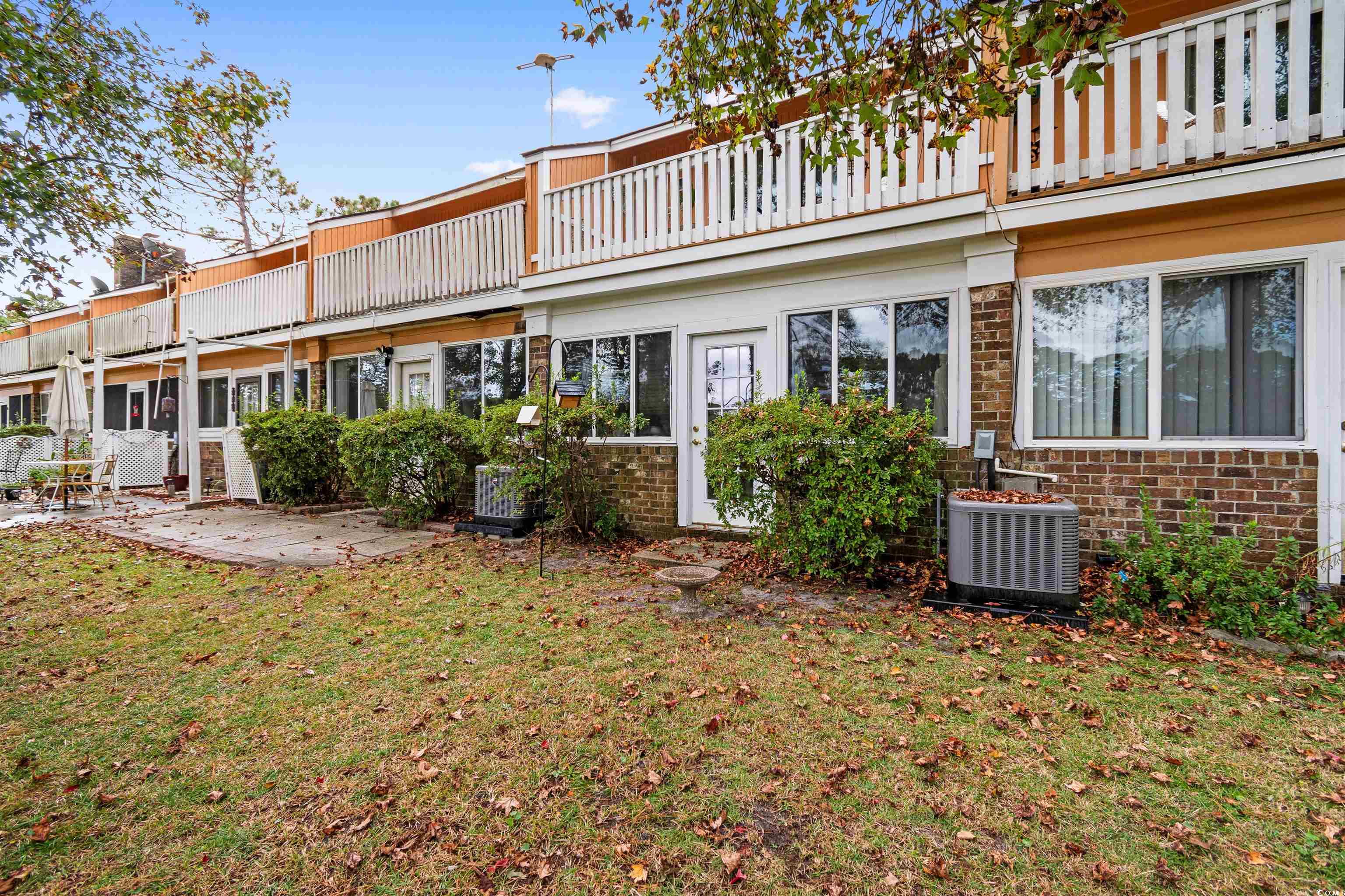 1830 Fairway Ridge Drive, Unit 6F Myrtle Beach, SC 29575 - Photo 25 of 31 Rear view of house with a patio, central AC unit,