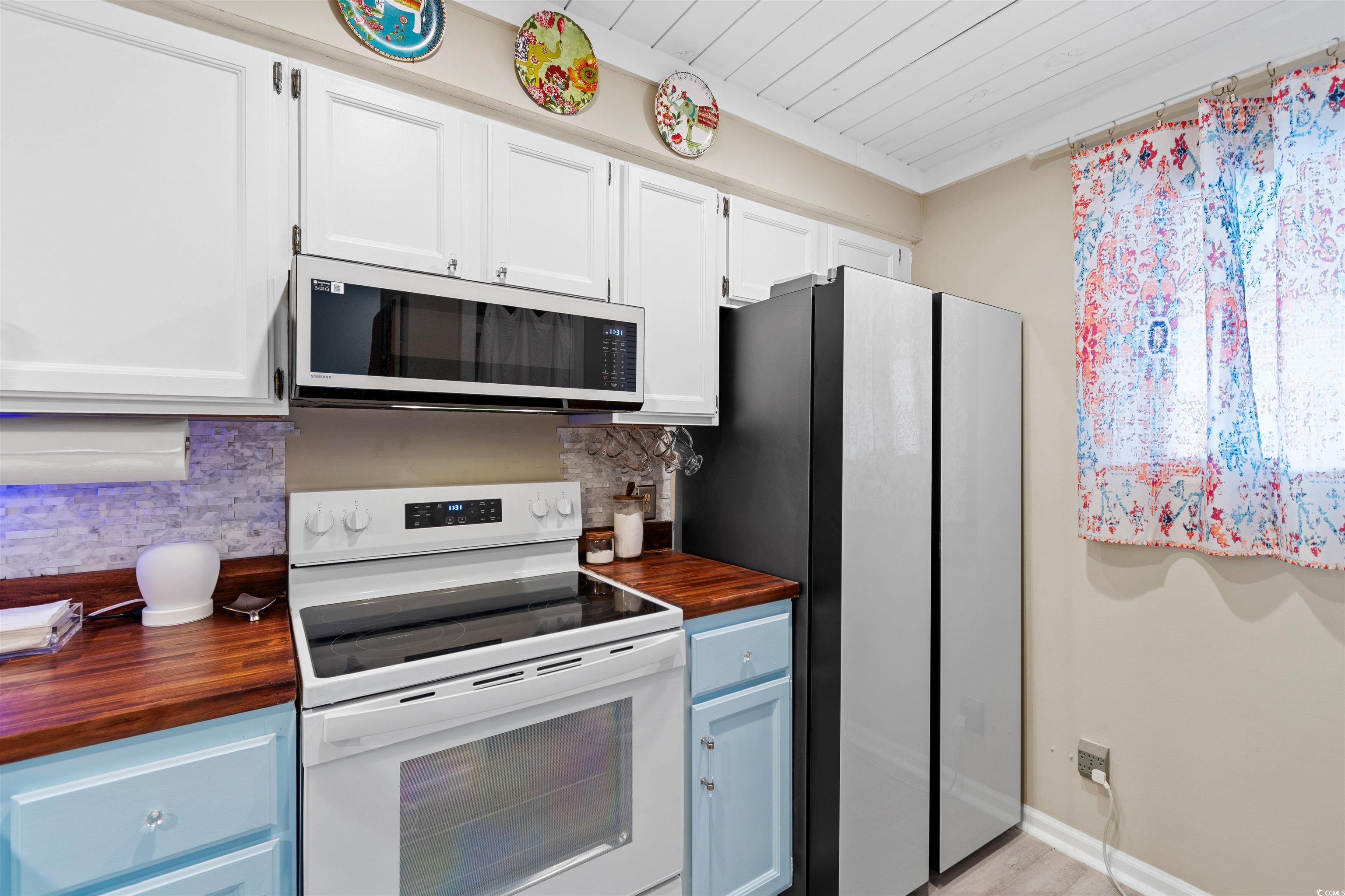 1830 Fairway Ridge Drive, Unit 6F Myrtle Beach, SC 29575 - Photo 9 of 31 Kitchen with wooden counters, appliances with stai